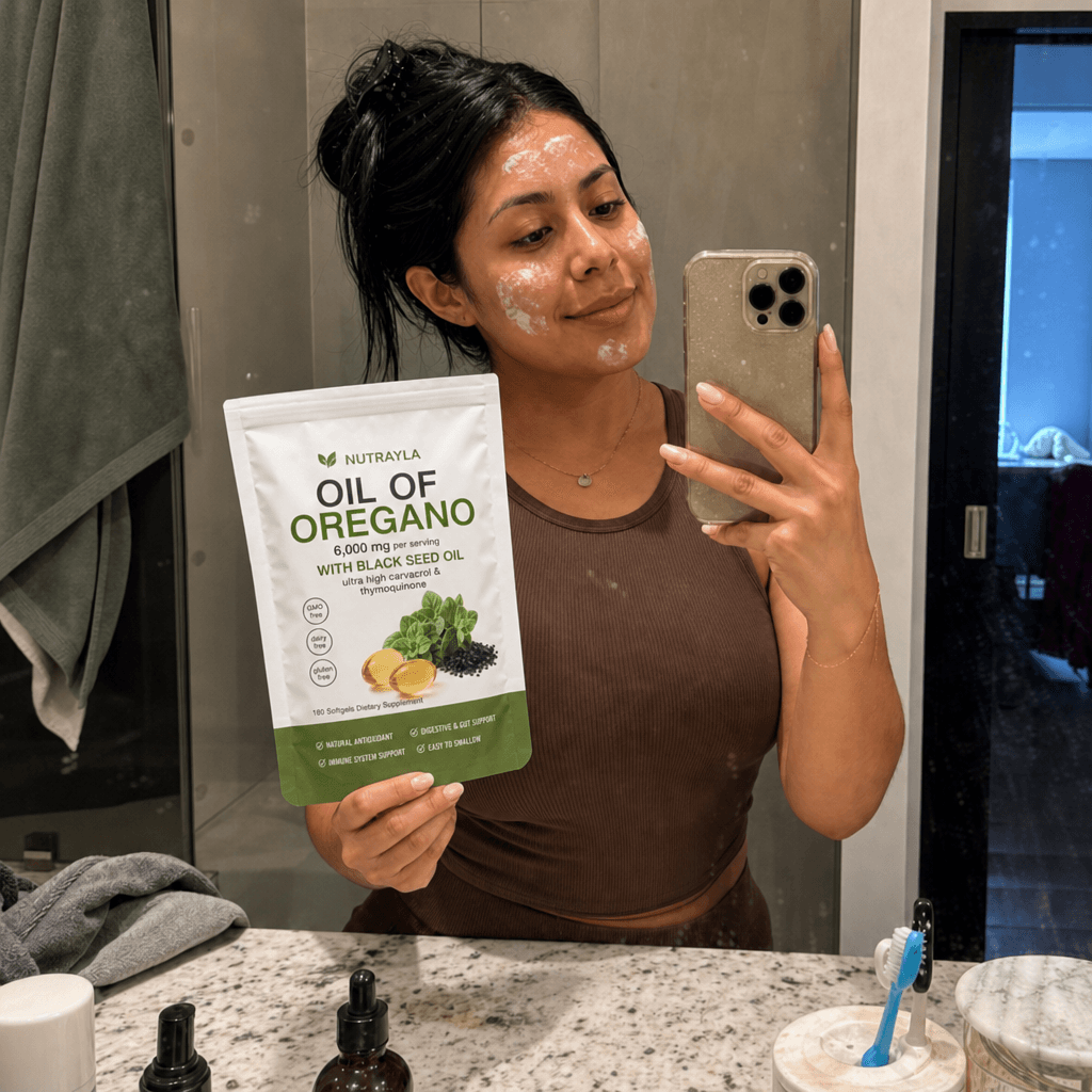 Bathroom mirror selfie with a NUTRAYLA oregano pouch during a morning routine