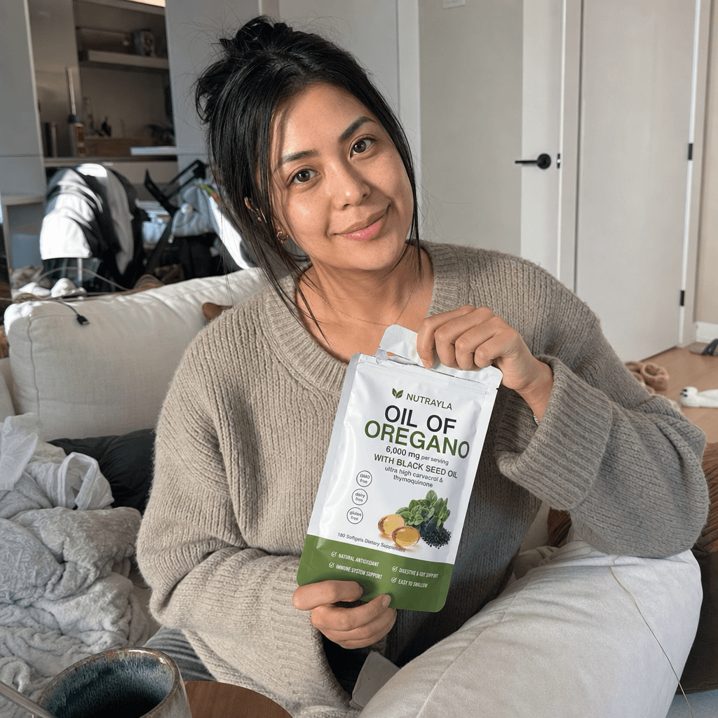 Home vlog moment opening a NUTRAYLA oregano pouch on the couch